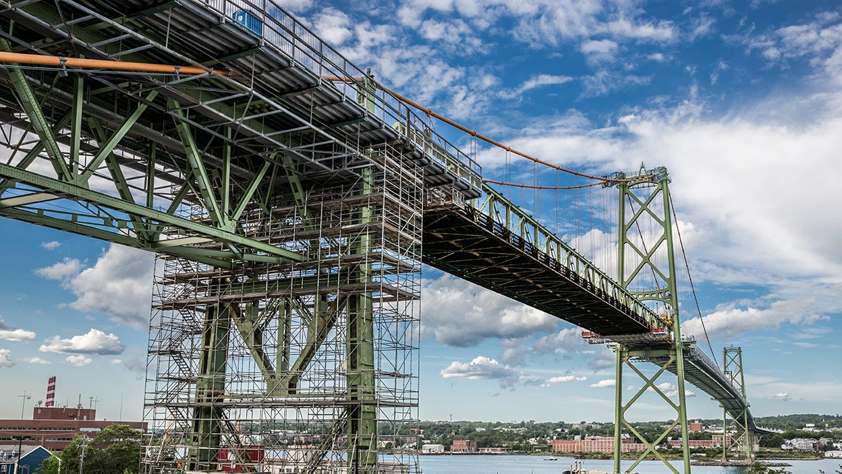Image of repairing a large bridge with Safeline-FP's debris netting systems for construction worker safety.